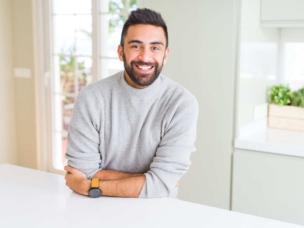 Man smiling in kitchen min