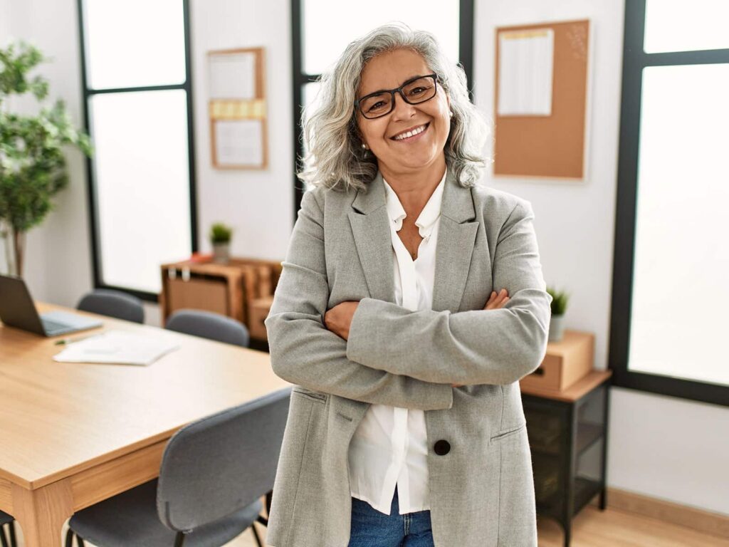 Mature woman smiling in office min