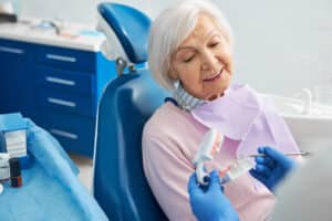 Elderly woman having a consultation with his dentist about dentures